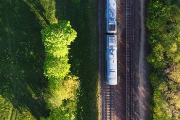 train driving through a green landscape