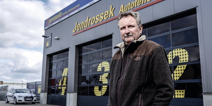 man in front of workshop