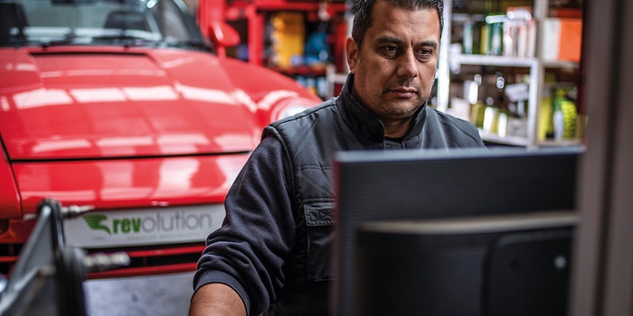 mechanic at computer in workshop