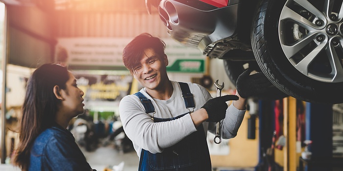trw workshop employee explaining what he is doing on a car
