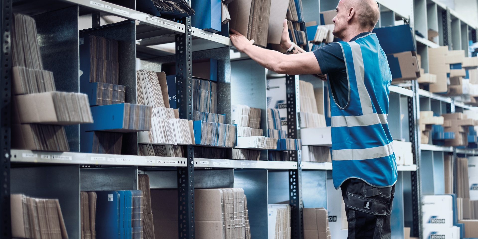 Man in front of box storage