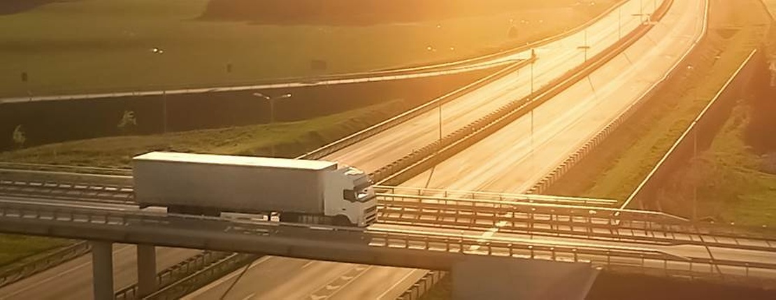 truck on bridge in sunset