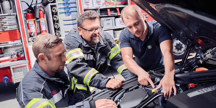 Three people during high-voltage training for fire brigades